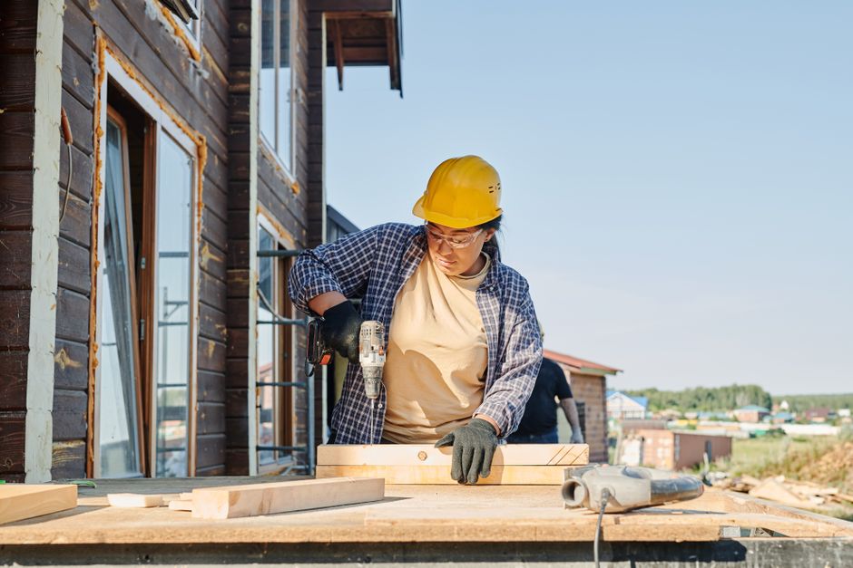 Carpenter framing a new custom home addition